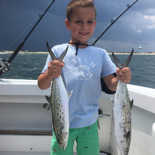 Boy holding two spanish mackerel OBX.