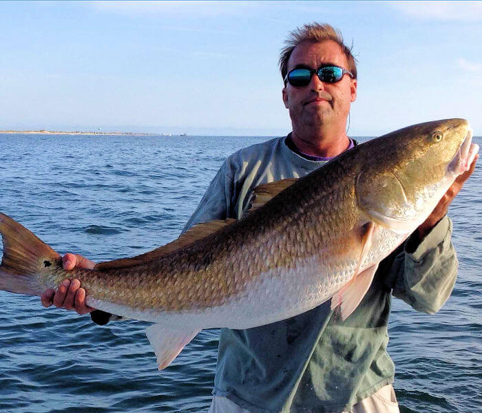 Captain Frank McCargo holding a red drum