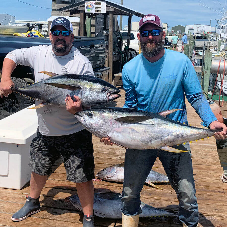 Charter members holding up tuna after Outer Banks trip.
