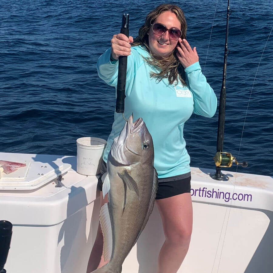 Lady angler showing off bottom fish OBX.