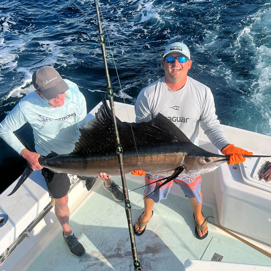 Anglers displaying sailfish before release.